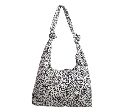 White Leopard print handbag with knotted shoulder straps on a white background