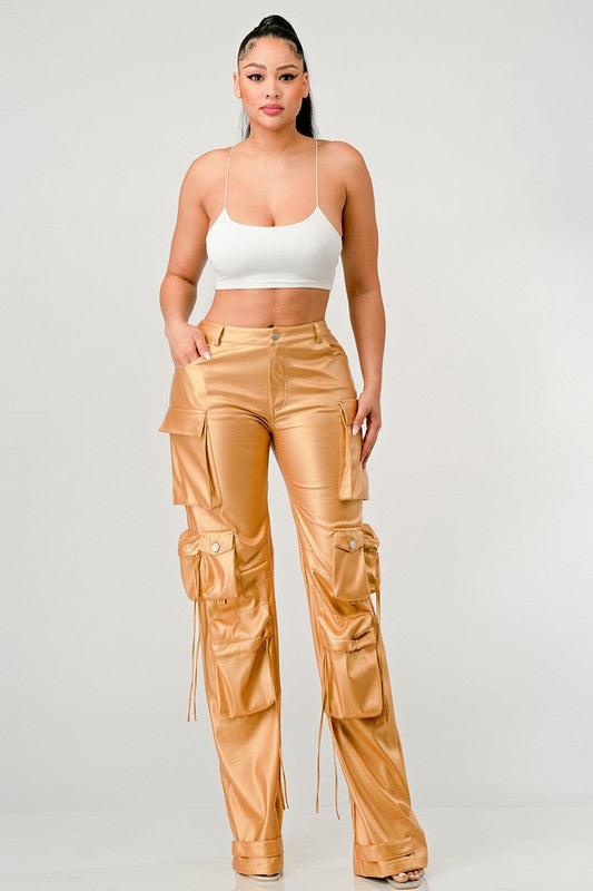 woman posing in a statement gold utility leather pants for women streetwear fashion