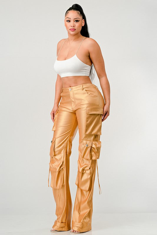 woman wearing gold high-quality faux leather street wear pants with oversized pockets  a luxe metallic shine