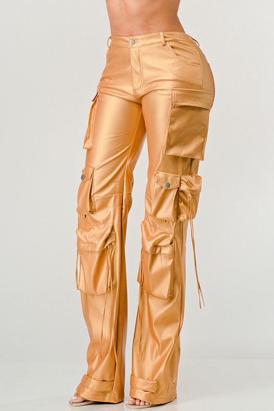 angle view of women's gold faux leather high waist cargo pants with luxe shine with oversized utility pockets