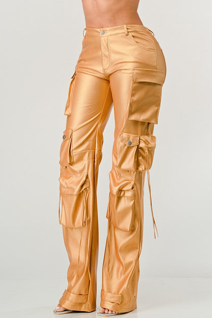 angle view of women's gold faux leather high waist cargo pants with luxe shine with oversized utility pockets