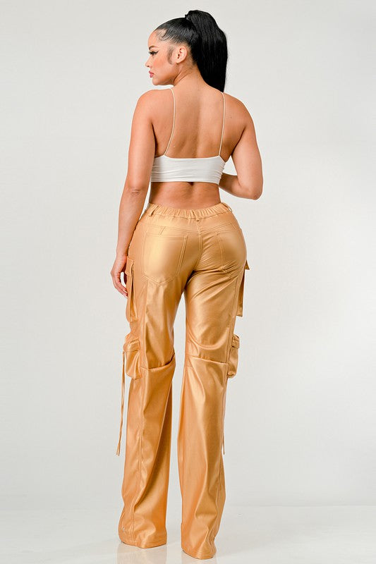 back view of woman wearing gold trendy PU leather pants on a white background-cruelty free fashion