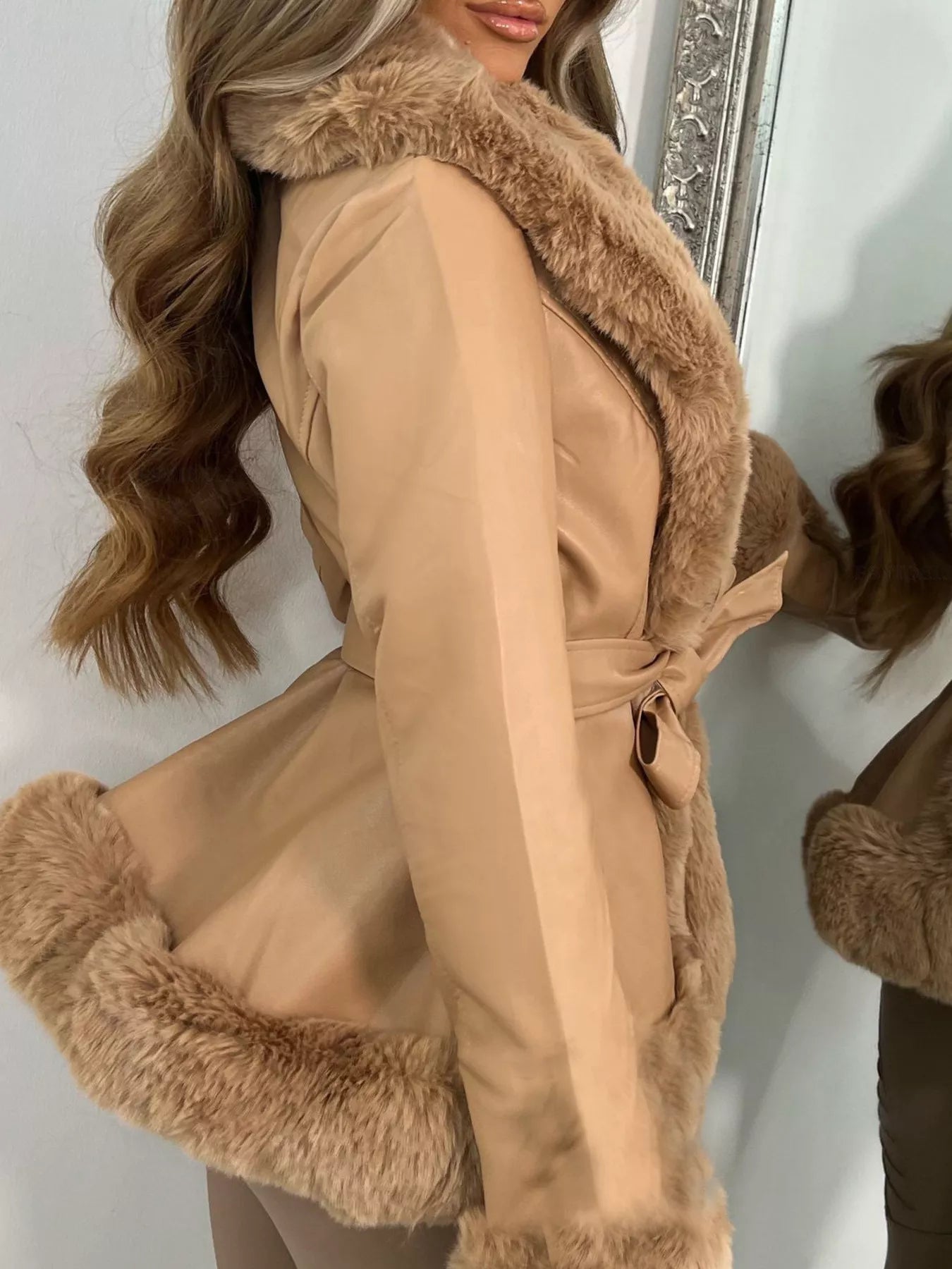 woman wearing a brown faux trimmed belted outerwear coat side view 