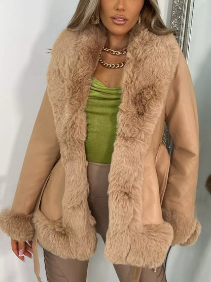 Woman wearing a beige coat with faux fur trim, standing against a white background