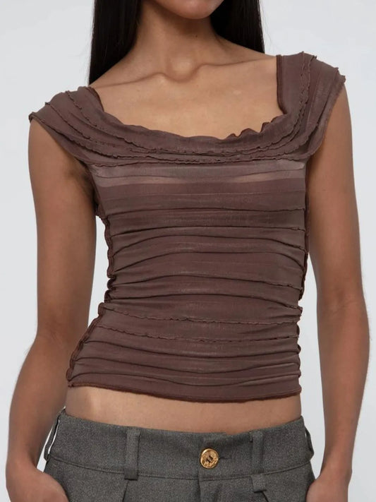 Brown ruched top worn by a model on a white background