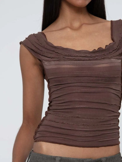 Brown ruched sleeveless top worn by a model on a white background