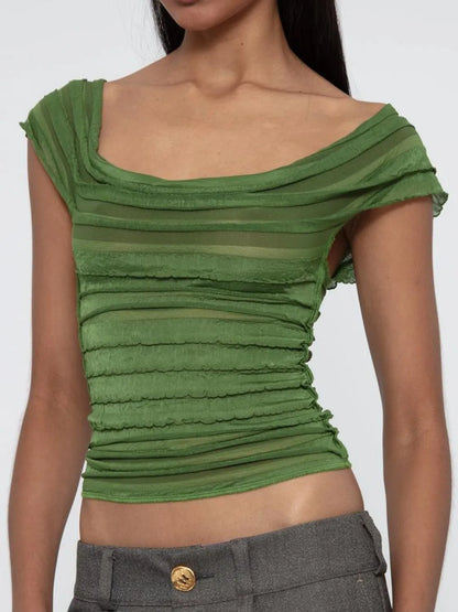 Green ruched sleeveless top worn by a model on a white background