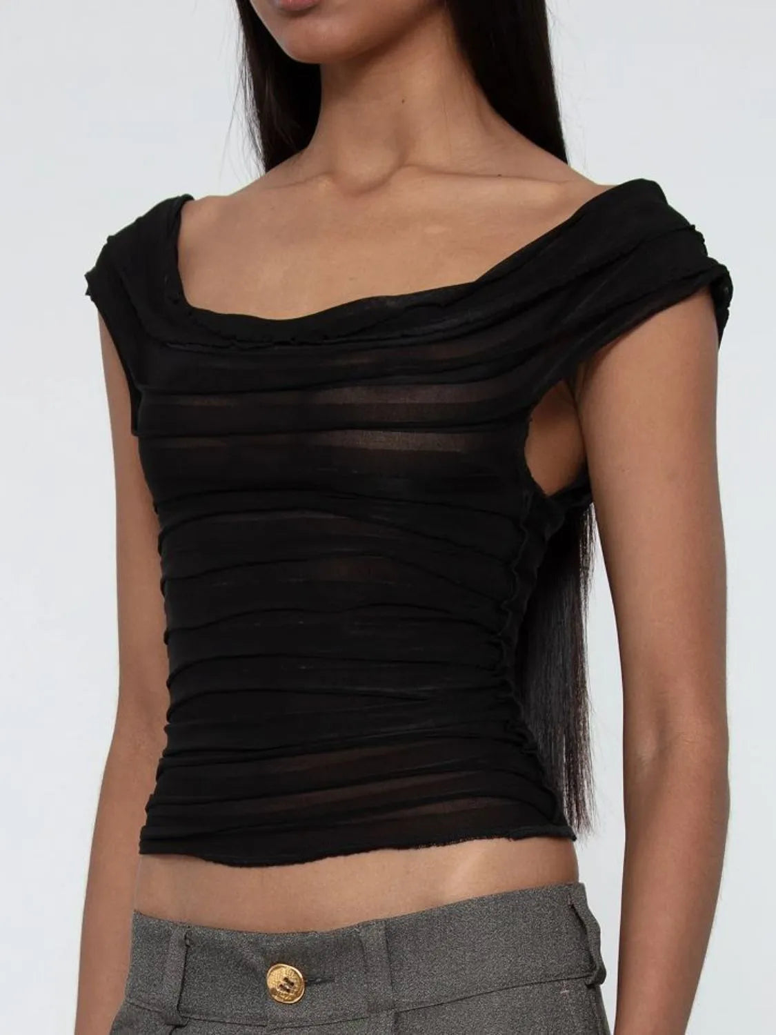 Black ruched sleeveless top worn by a model on a white background