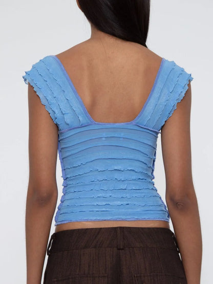 Blue sleeveless ruched top worn by a woman back view on a white background