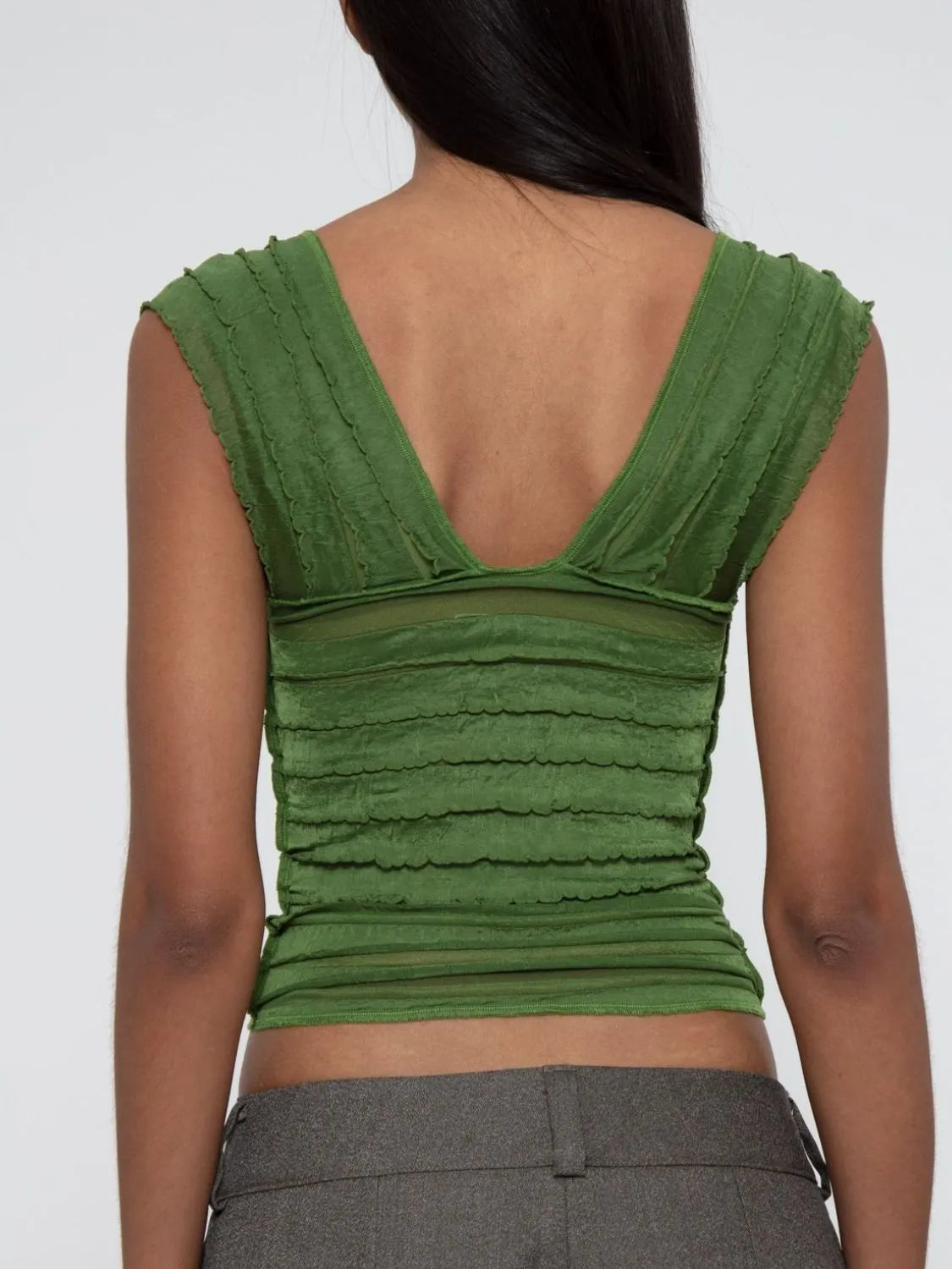 Green sleeveless ruched top  back view worn by a woman on a white background