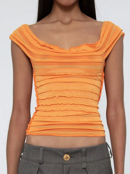 Orange ruched sleeveless top worn by a woman on a white background