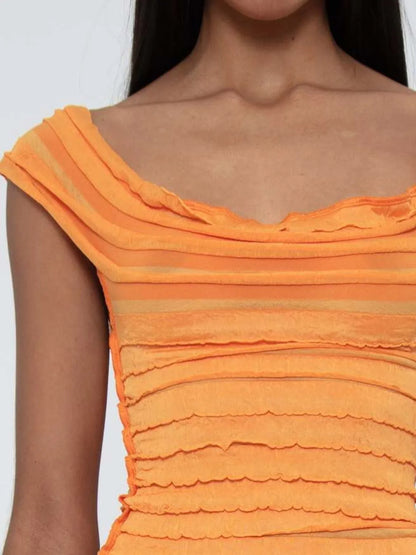 Close-up of an orange ruched sleeveless top on a woman on a white background