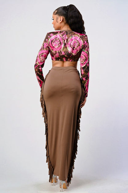 Woman wearing a pink and brown floral crop top and high waist tassel skirt set back view