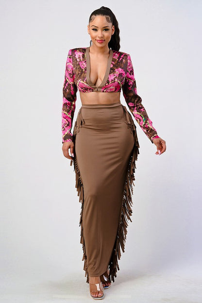 Woman wearing a pink and brown floral crop top and high waist tassel skirt set front view