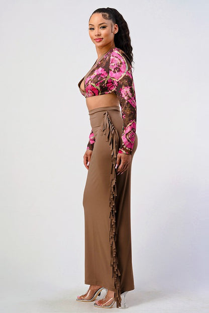 side view of brown and pink floral crop top and high rise tassel stretchy two piece set worn by a woman on a white background