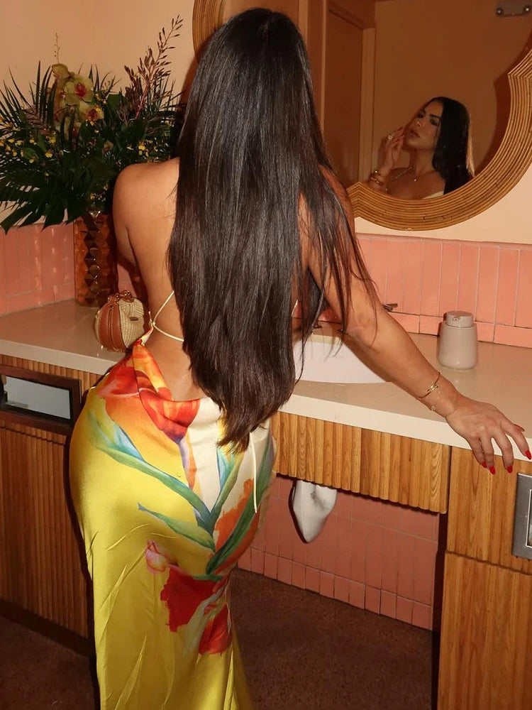 woman wearing floral print lace-up backless maxi dress in tropical style resort bathroom back view
