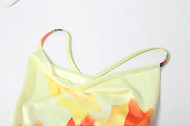 Close up of floral print maxi dress with lace up back neckline on a white background