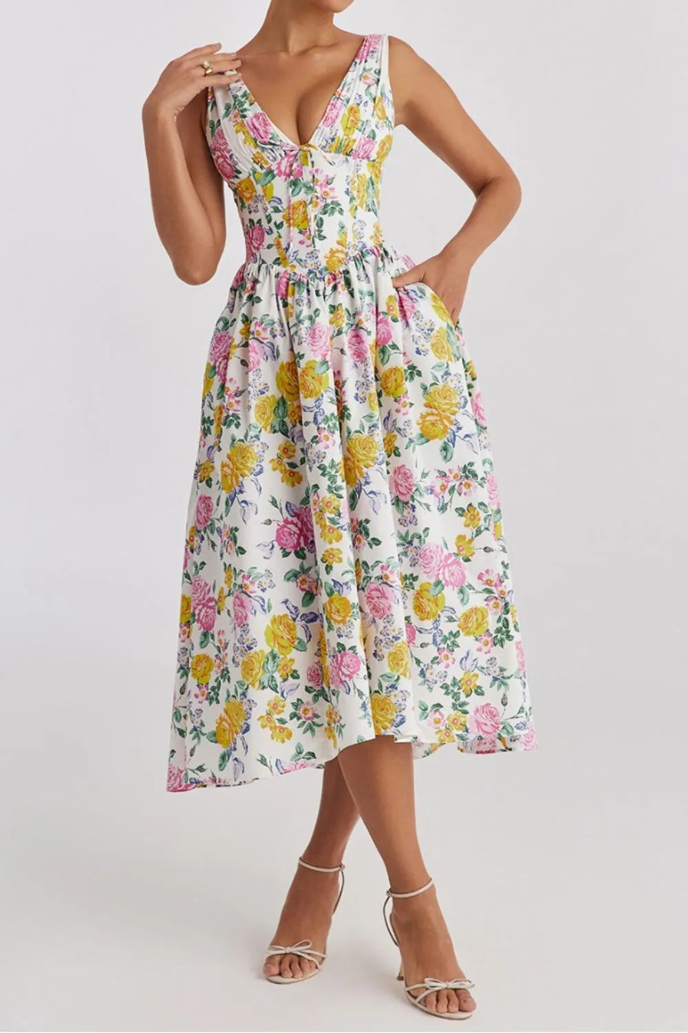 Woman wearing a vibrant multicolor floral v-neck sleeveless flowy midi dress  with pockets front view 