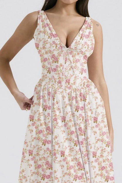 Close up of woman wearing white and pink floral sleeveless midi dress on a white background