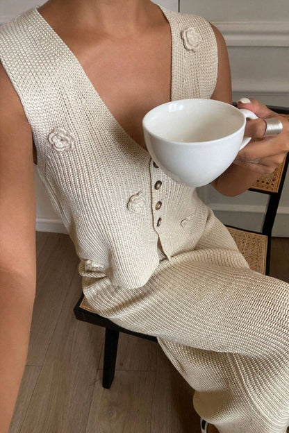 Two-piece preppy outfit with vest and skirt for women in tan on model sitting down holding a mug