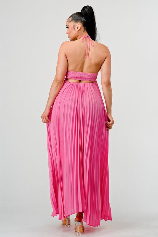 Woman wearing a pink backless halter neck pleated maxi dress in pink