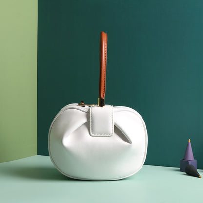A white leather dumpling handbag with a buckle closure and a single handle, displayed against a two-tone background 