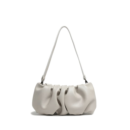 White pleated real leather handbag with gathered design and structured silhouette on a white background
