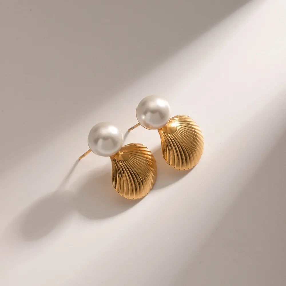 Sculptural gold plated shell earrings for beach or resort style