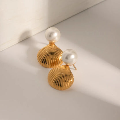 18K gold plated stainless steel shell earrings for women on white surface