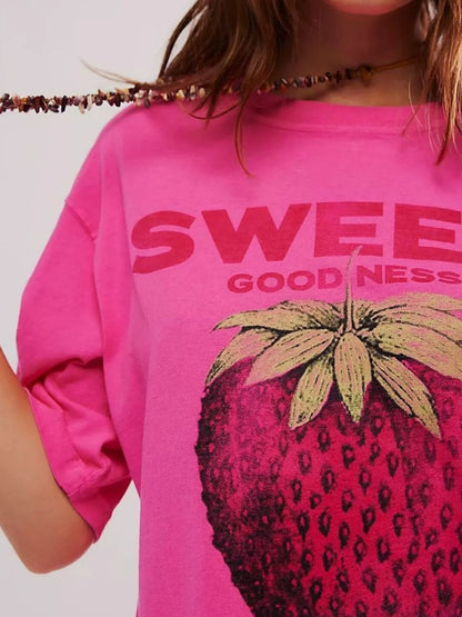 Close up of woman wearing graphic streetwear tee with strawberry design with relaxed fit
