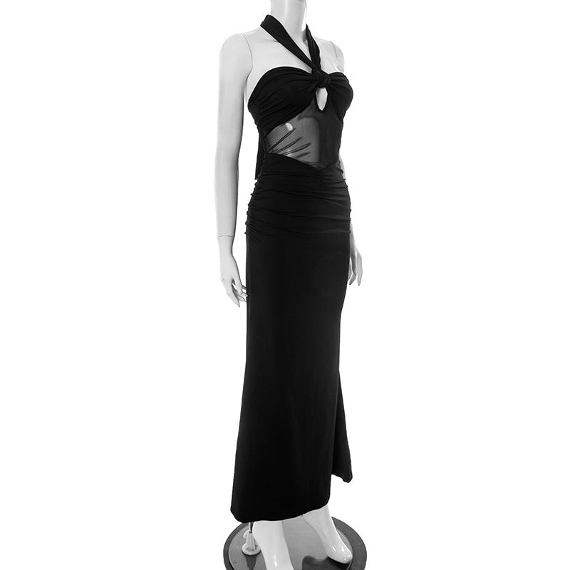 Side view of black knotted halter evening maxi dress on a mannequin against a white background