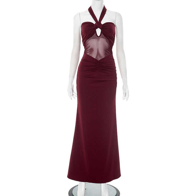 Front view of red/burgundy halter backless evening party dress with sheer mesh bodice on a mannequin against a white background