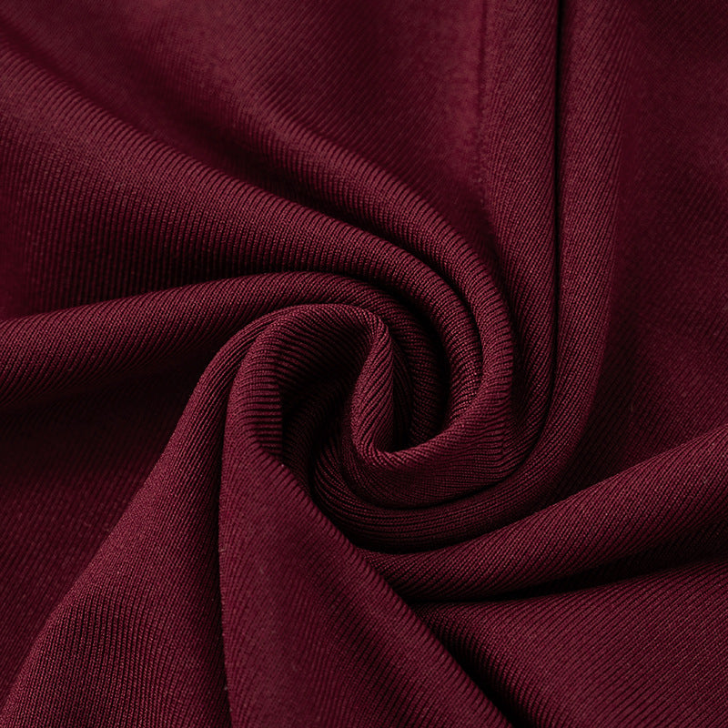 Close-up of dark red/burgundy polyester fabric for red evening maxi dress