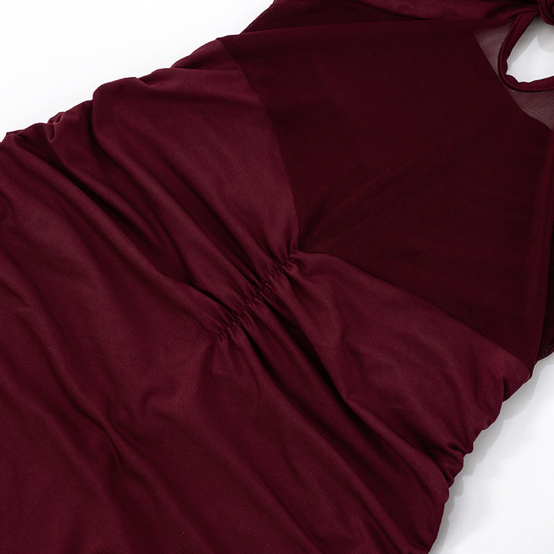 Close-up of scrunch waist of red/burgundy Halter Backless Tulle Maxi Dress with a knot on a white background
