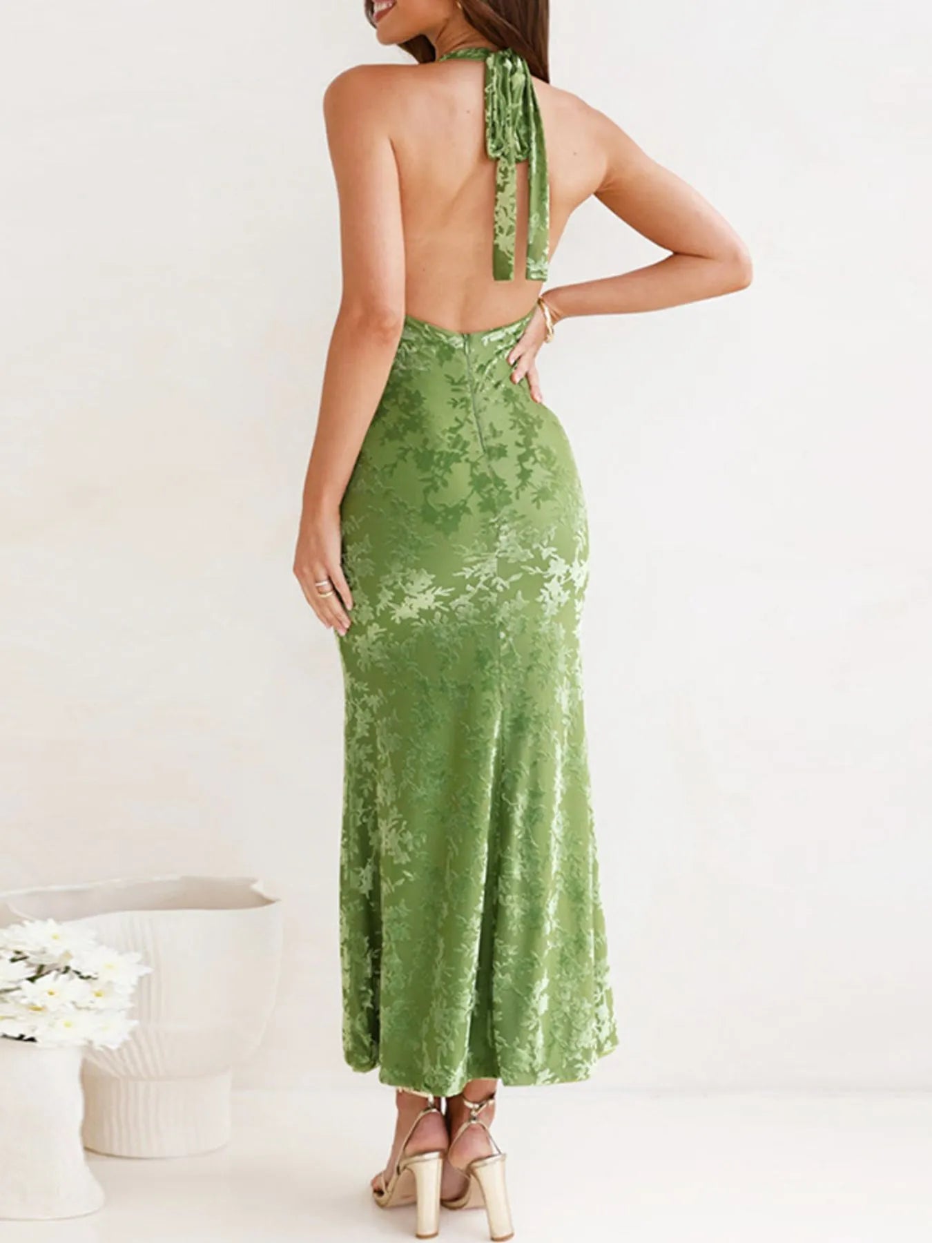 Green Halter Neck Cutout Midi Dress with open back worn by a woman on a white background