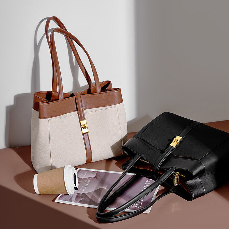 Two genuine leather Shoulder bags, one brown and beige, the other black, on a surface with a coffee cup and magazine.