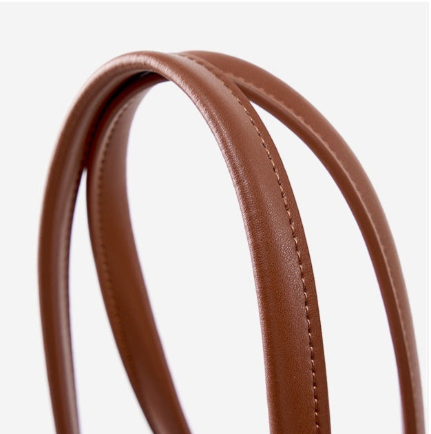 Close up of brown genuine leather shoulder strap with on a white background