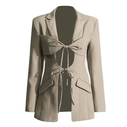 A luxury fashion inspired  beige/khaki hollow-out cinched irregular  longs sleeve blazer with a deep v-neckline and lace up front detail on a white background