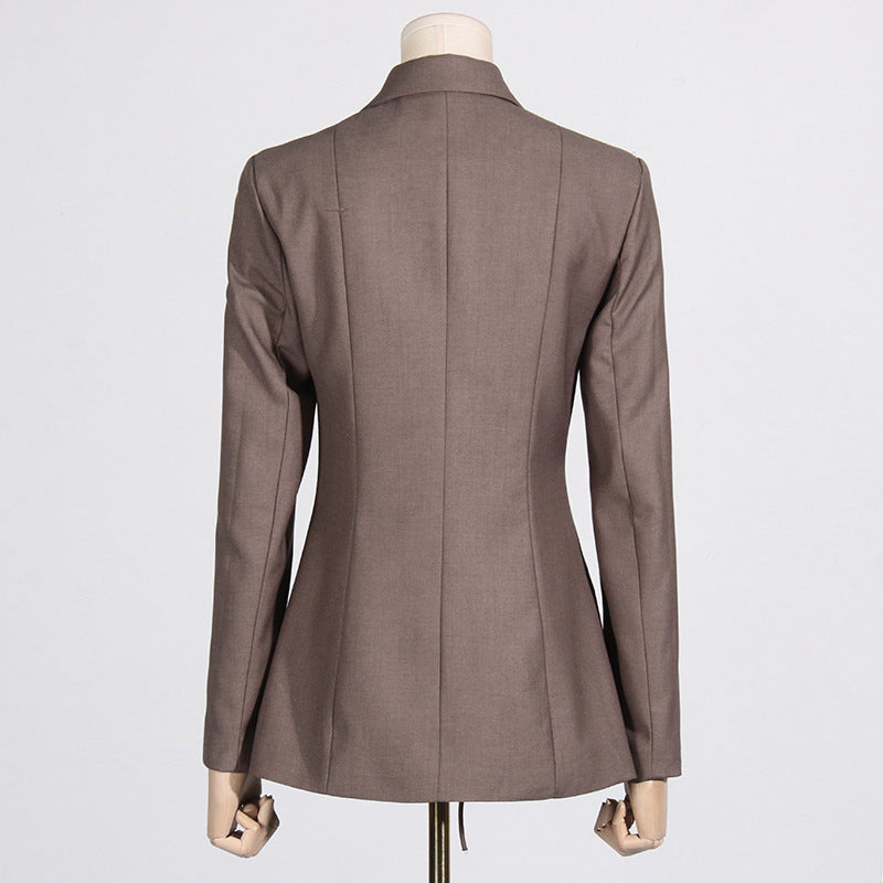 Back view of a luxury fashion inspired  beige/khaki hollow-out cinched irregular  longs sleeve blazer with a deep v-neckline and lace up front detail on a mannequin