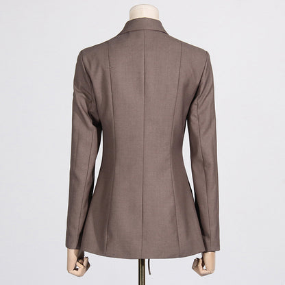 Back view of a luxury fashion inspired  beige/khaki hollow-out cinched irregular  longs sleeve blazer with a deep v-neckline and lace up front detail on a mannequin