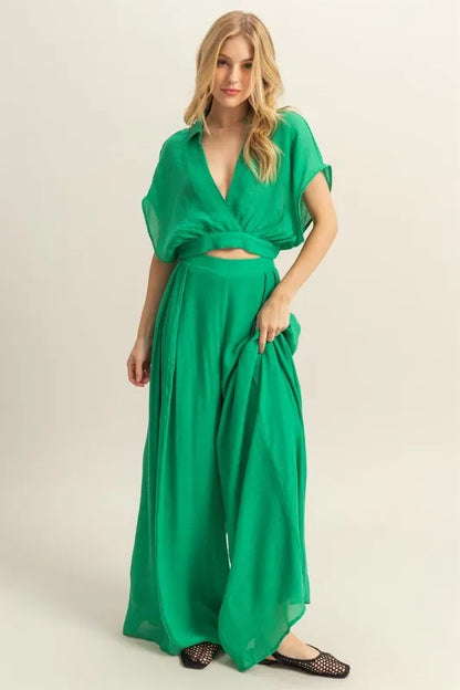 Stylish summer outfit featuring kimono sleeve top and wide leg pants in green on model front view