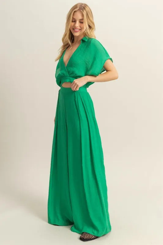 Stylish summer outfit featuring kimono sleeve top and wide leg pants in green on model