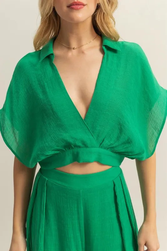 Women's boho two-piece set with kimono sleeve crop top view front on model in green color