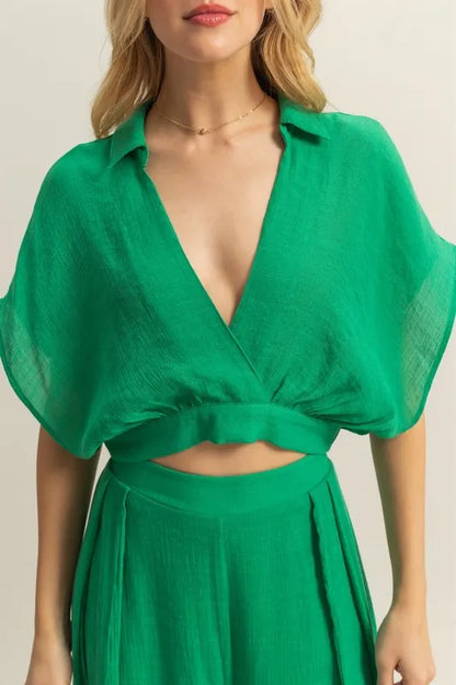 Women's boho two-piece set with kimono sleeve crop top view front on model in green color