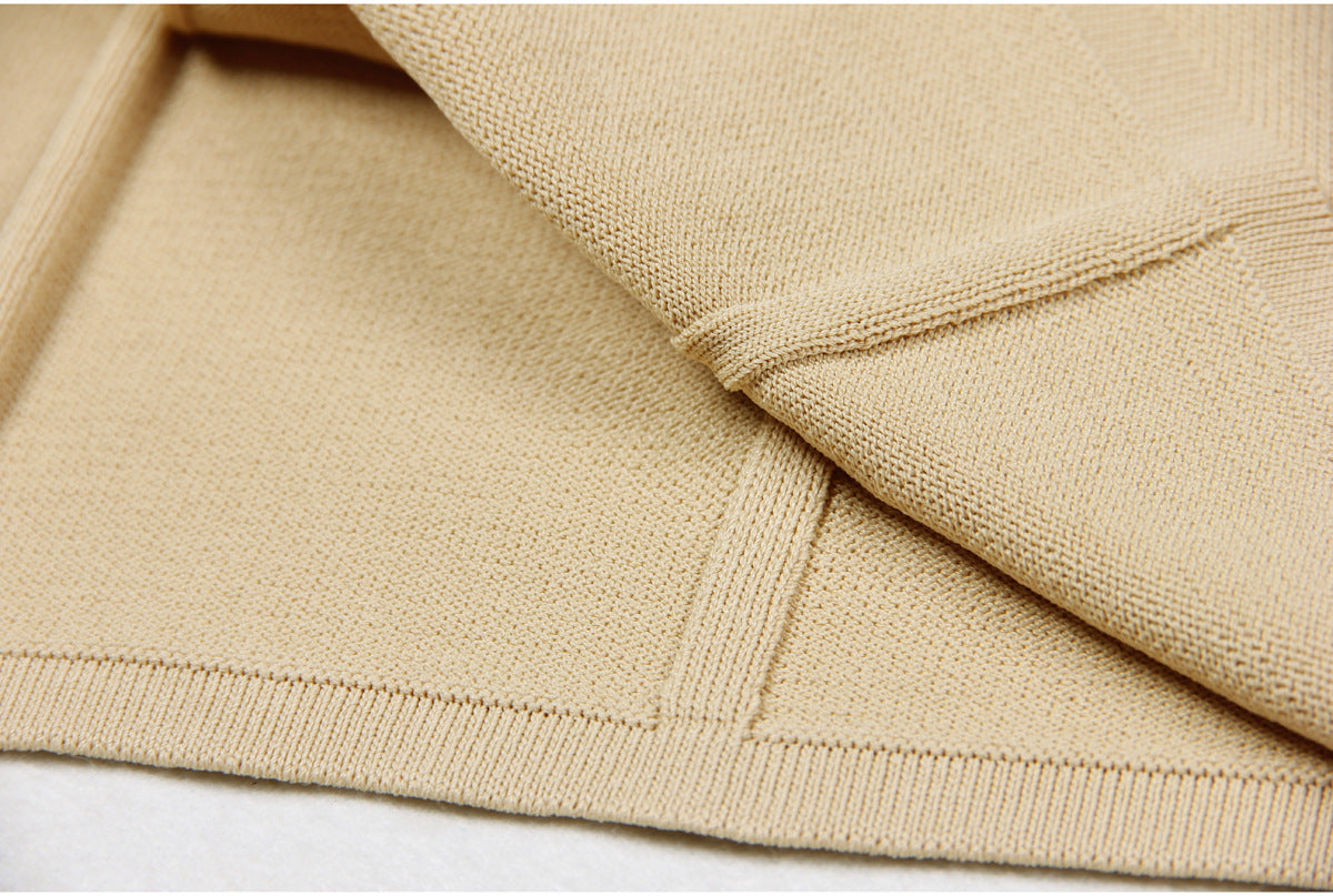 Close-Up of hemline of beige/apricot  Luxury Knit mini Dress with Lapel Collar and Buttons for women fashion
