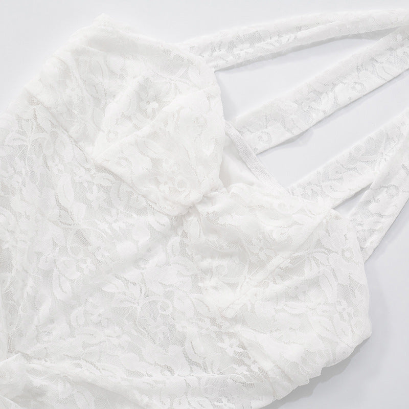 Close up of lace backless maxi dress halter neckline on a light gray background