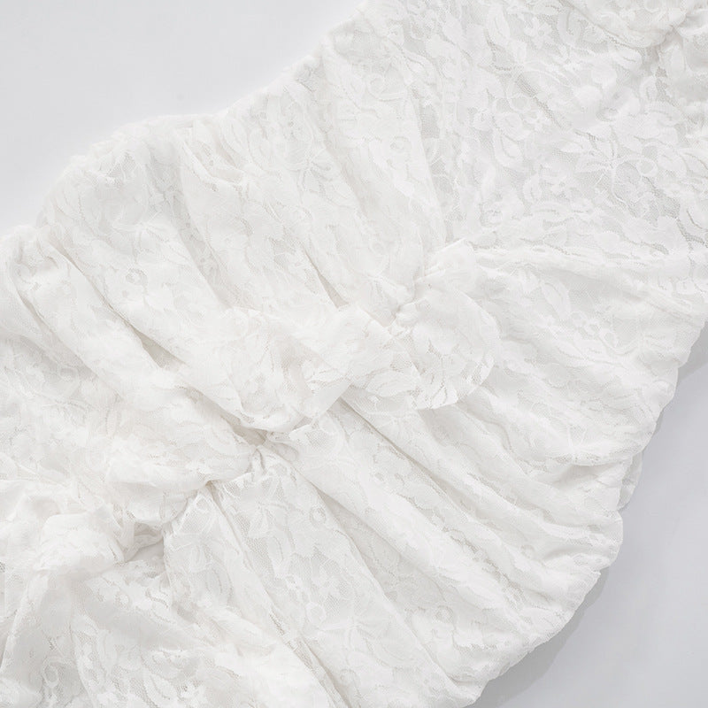 close up of scrunch skirt of lace backless slit  maxi dress on a light background