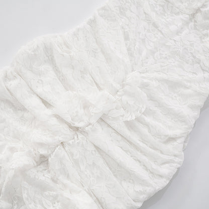 close up of scrunch skirt of lace backless slit  maxi dress on a light background