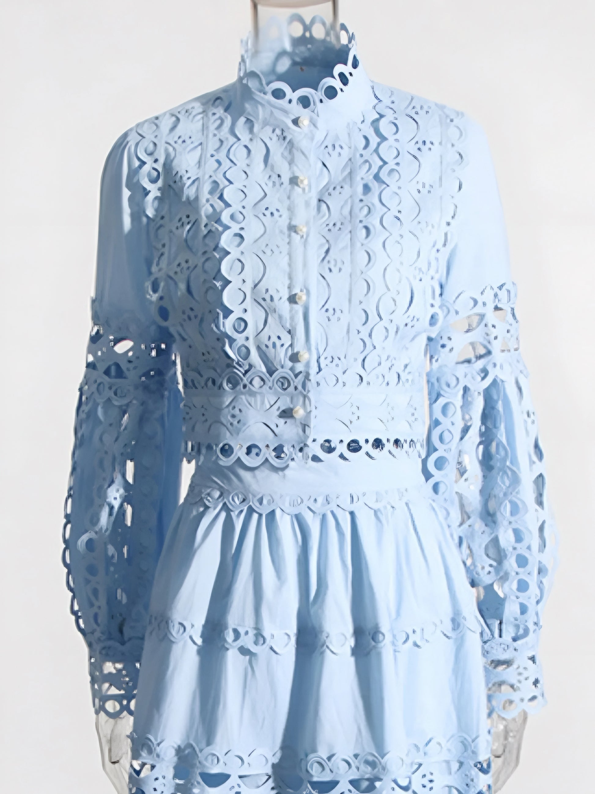 Light blue lace cut out long sleeve top with maxi skirt two piece set on a mannequin against a white background