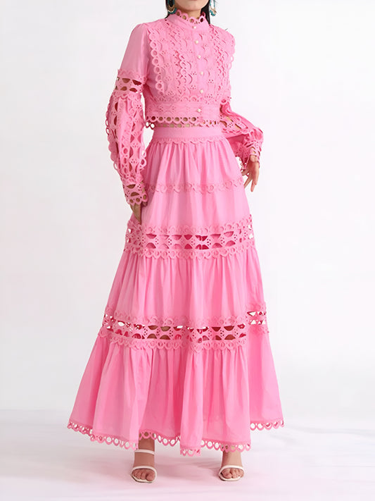 Elegant , formal pink long sleeve top and tiered maxi skirt with lace and cut-out details on a white background